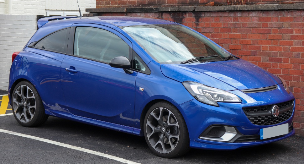 Sporty blue hatchback with sharp headlights and large alloy wheels