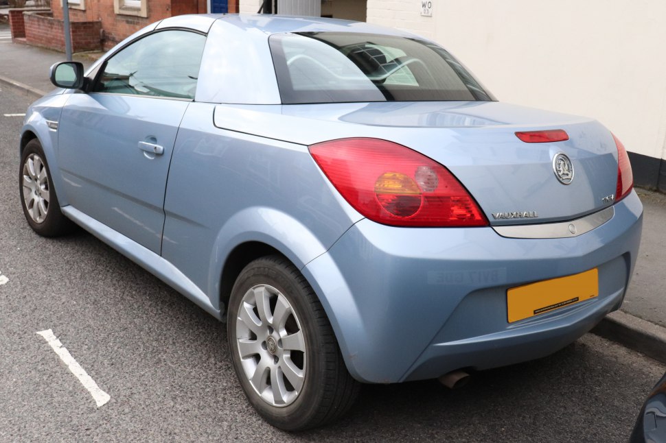 Rear side view of a compact sporty coupe with distinct rear lights and alloy wheels