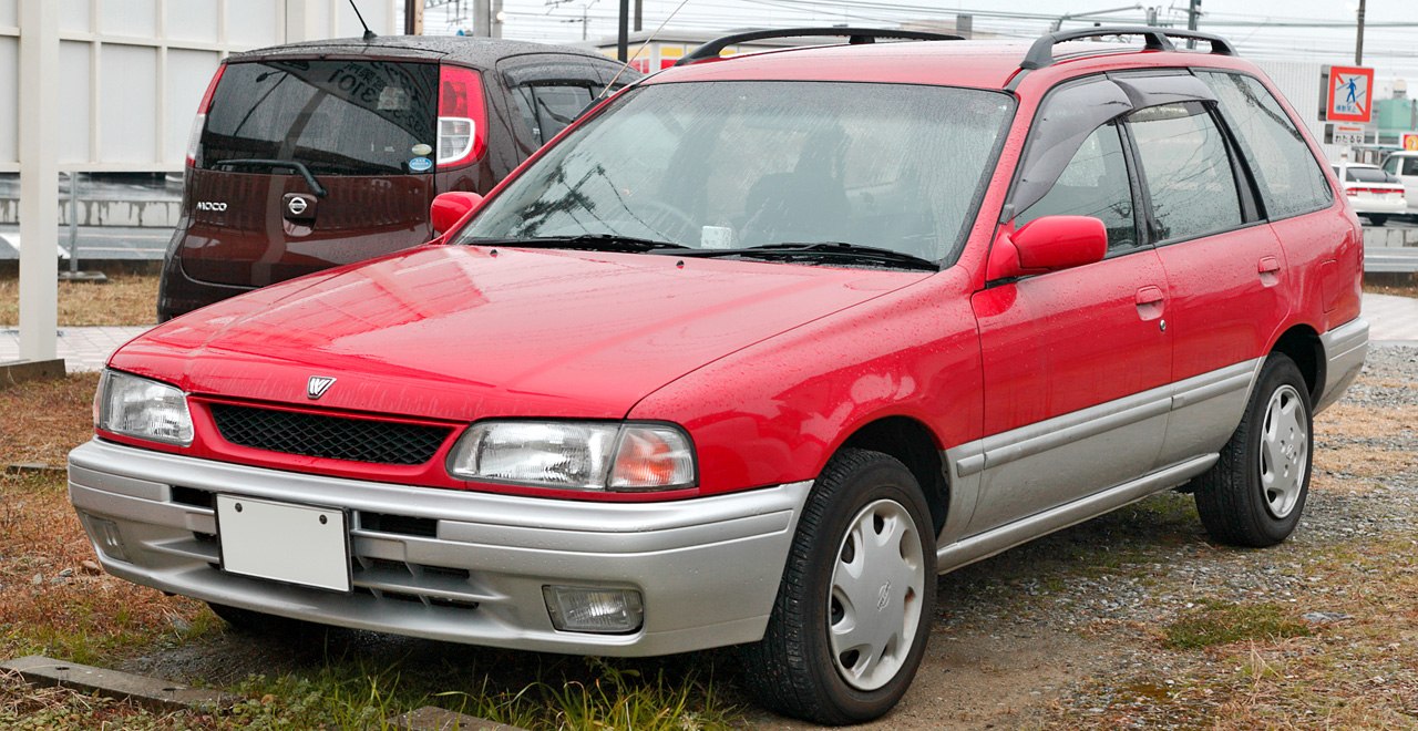 Front-side view of a red and silver wagon with roof rails