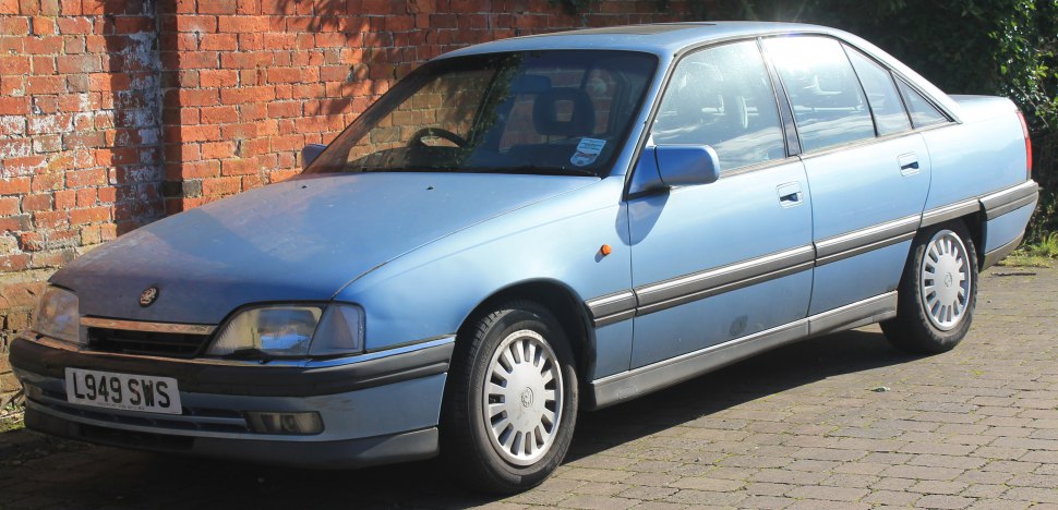Blue four-door sedan with alloy wheels, side profile view