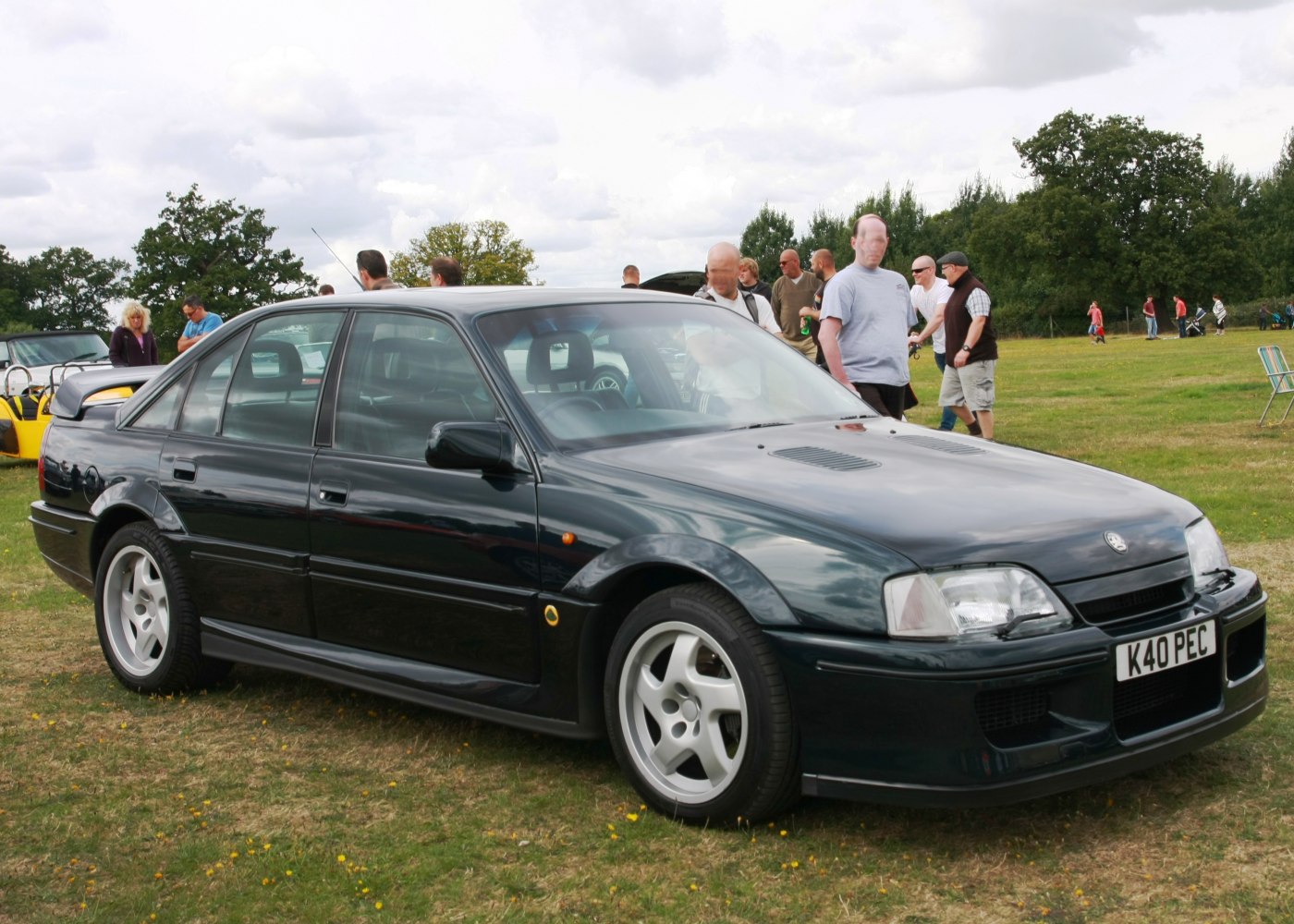 Side view of a black sedan with alloy wheels and body vents