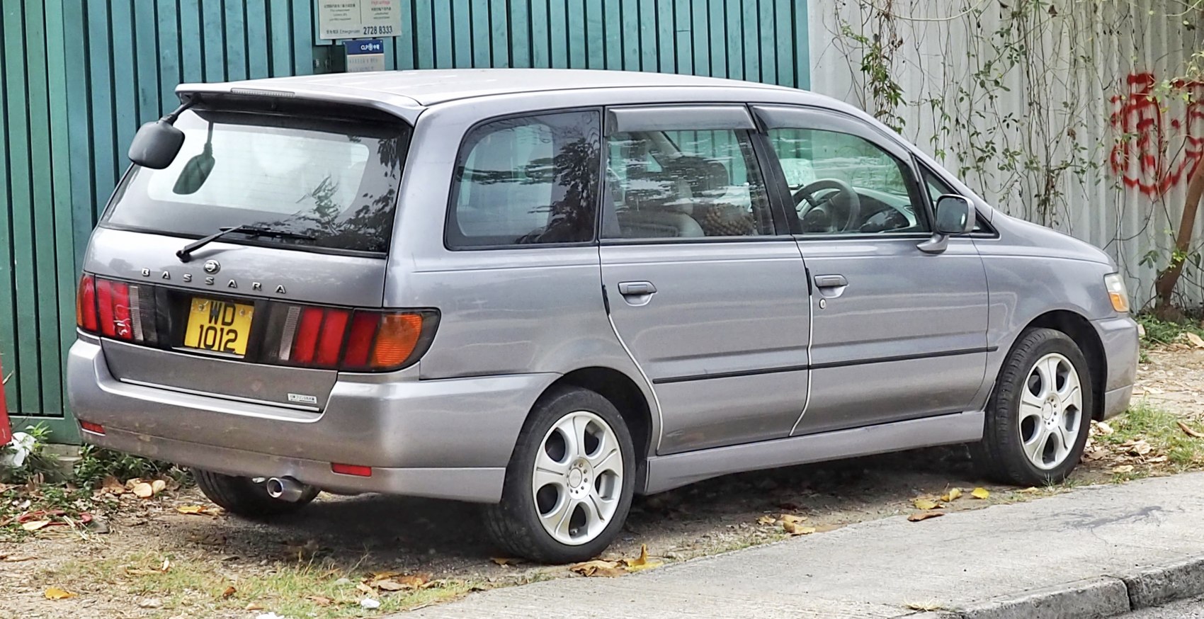 Rear side view of minivan with alloy wheels and distinct taillights