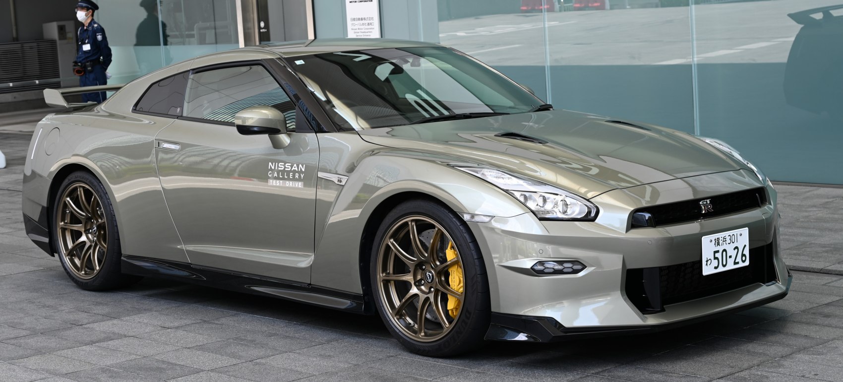 Front-side profile of a sports coupe with bronze alloy wheels and aerodynamic features