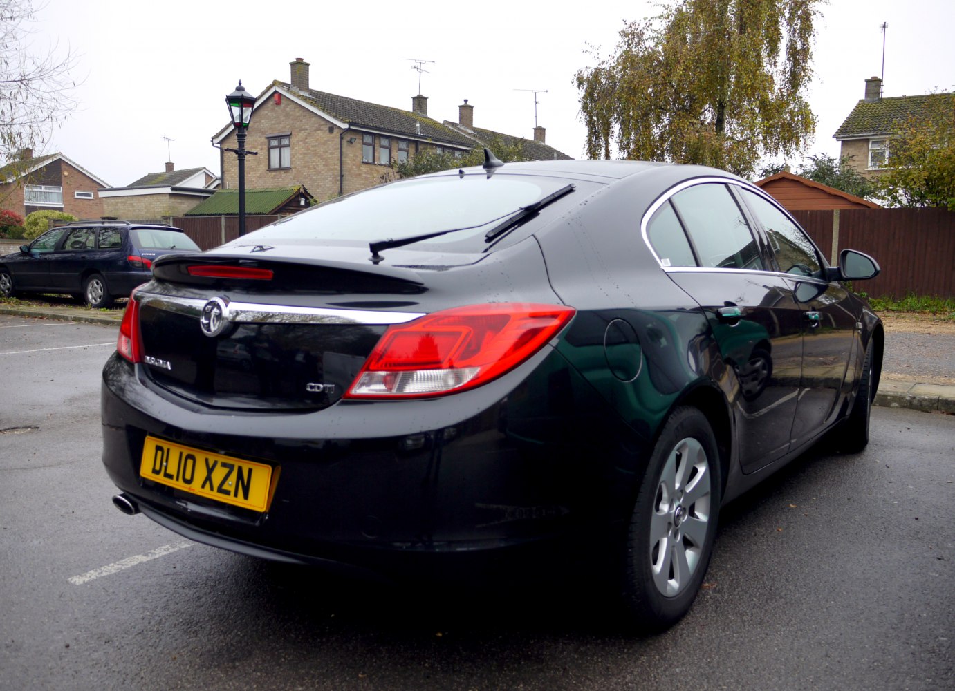 Rear view of hatchback with distinct tail lights and rear windshield wiper