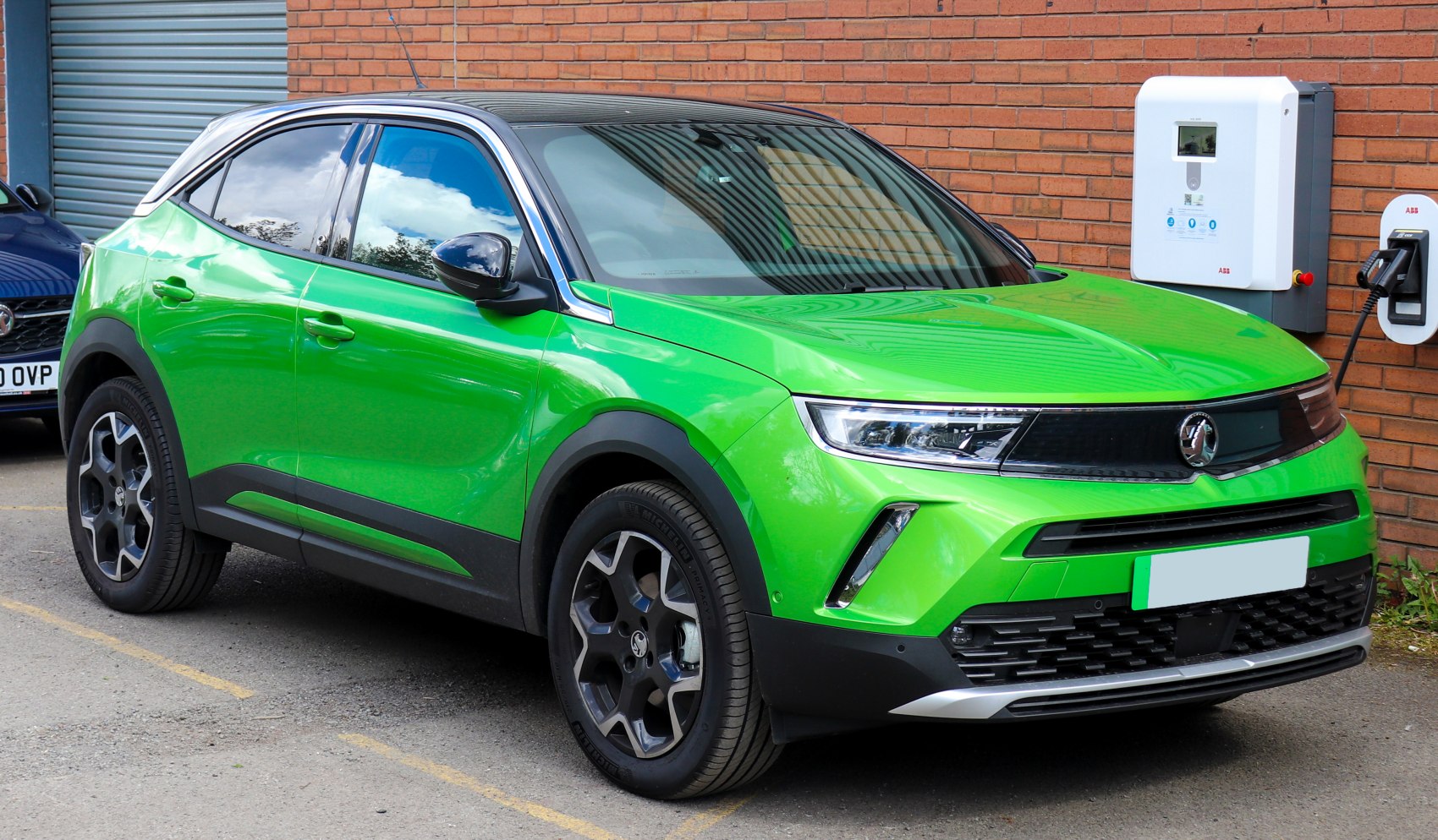 Front and side view with LED headlights and angular modern styling.
