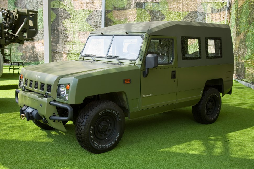 Military style utility vehicle with winch and camouflage soft top