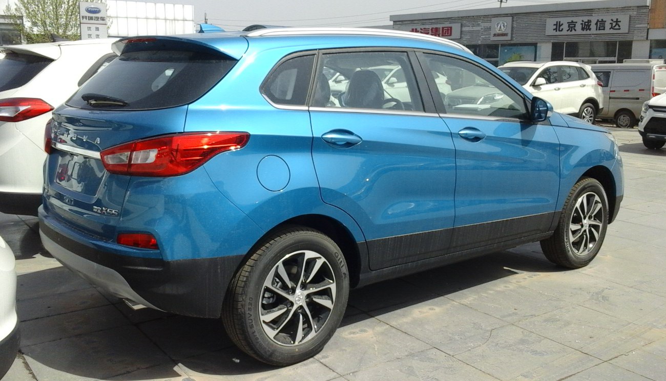 Rear-side view of blue compact SUV with alloy wheels