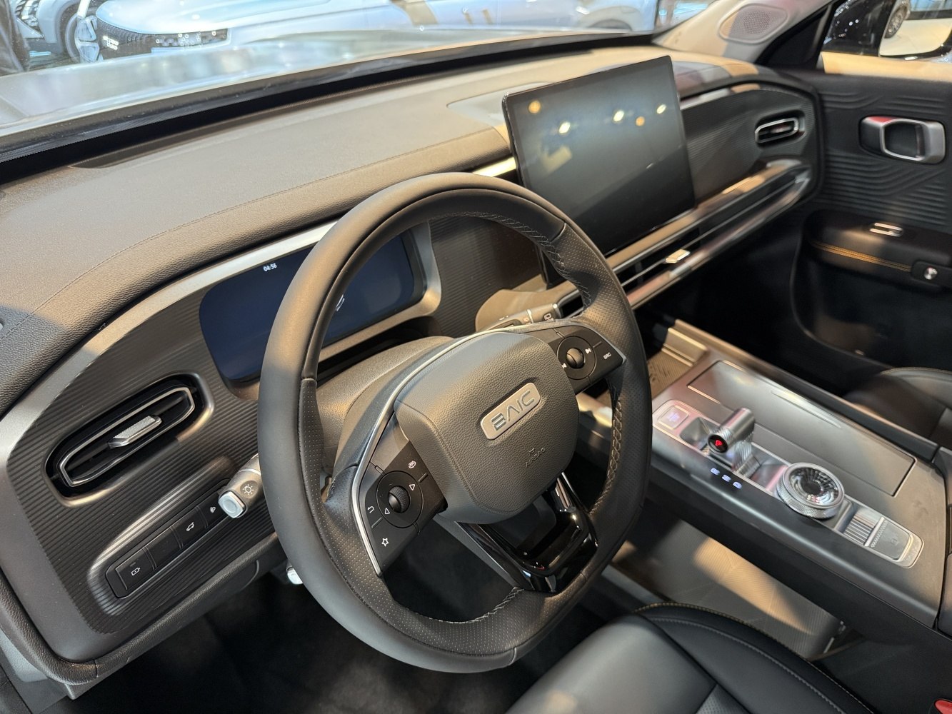 Modern car interior dashboard with multifunction steering wheel and touchscreen display