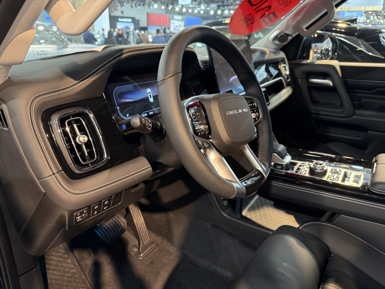 Modern steering wheel with controls and digital instrument cluster.