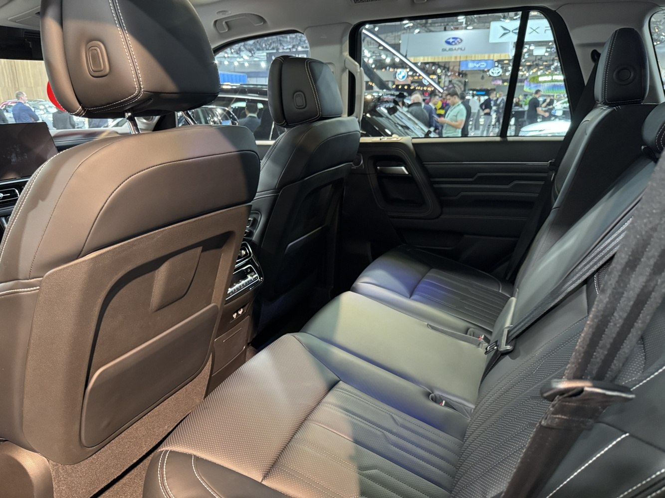 Premium rear seating with black leather upholstery and spacious interior.