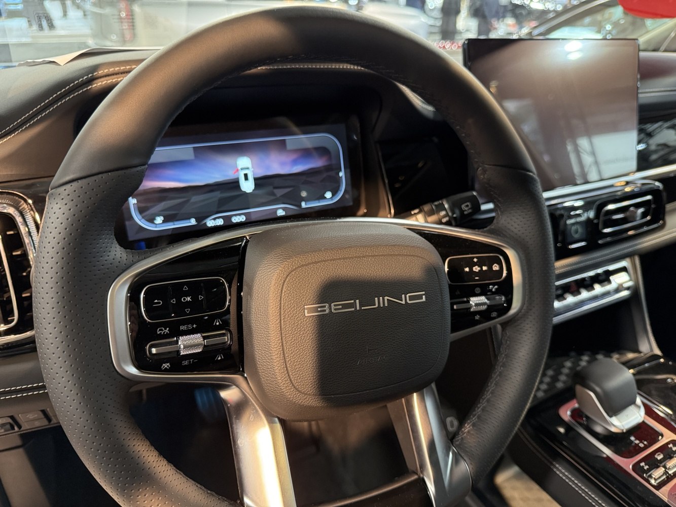 Close-up of steering wheel with controls and digital dashboard display