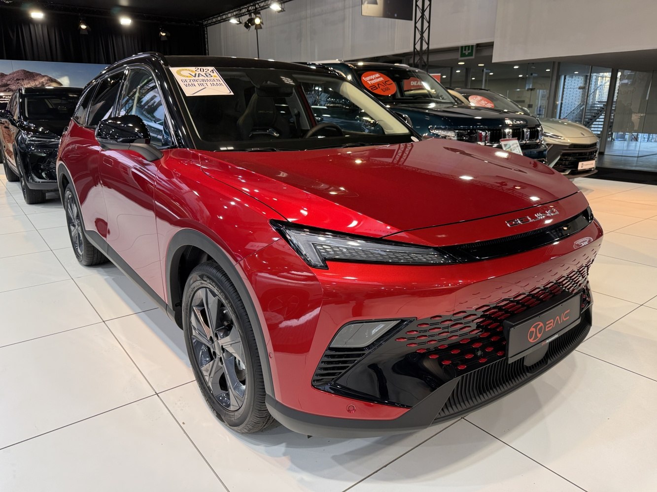 Red SUV with sharp LED headlights and black-accented front grille