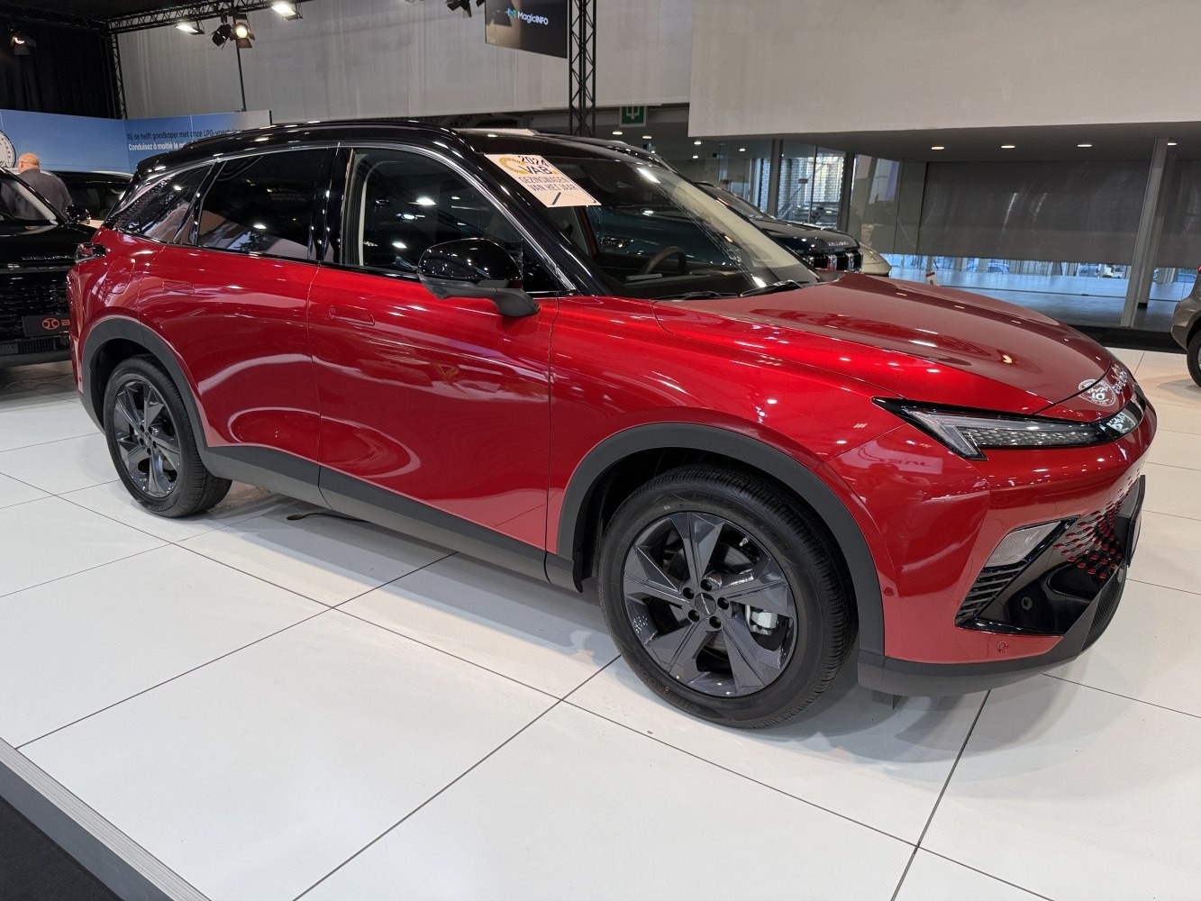 Red modern SUV with black alloy wheels and LED headlights