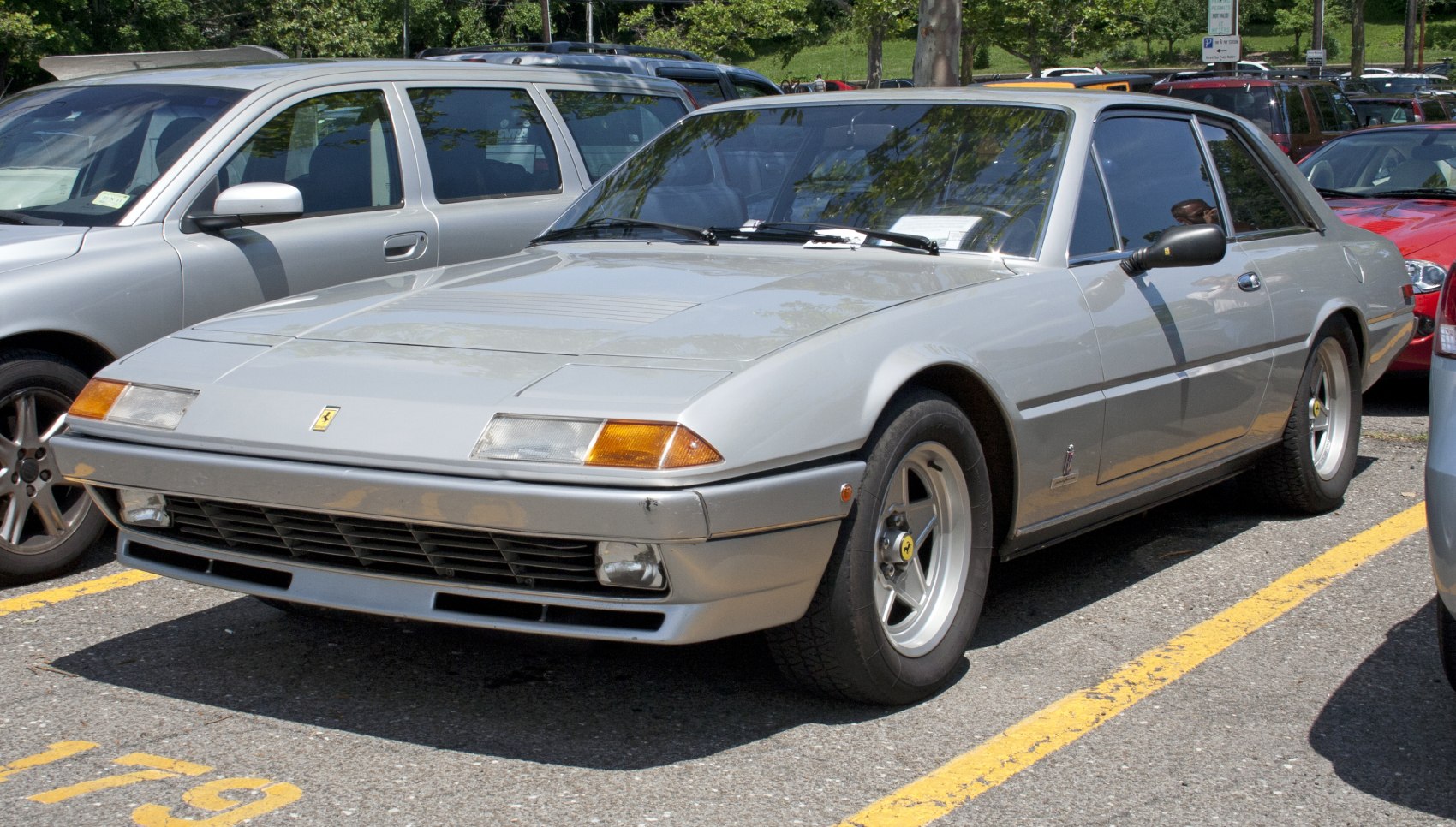 Silver sports coupe with pop-up headlights and sleek aerodynamic design