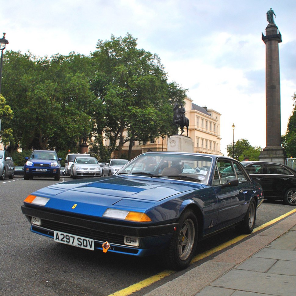 Blue Ferrari coupe with pop-up headlights and sporty front design