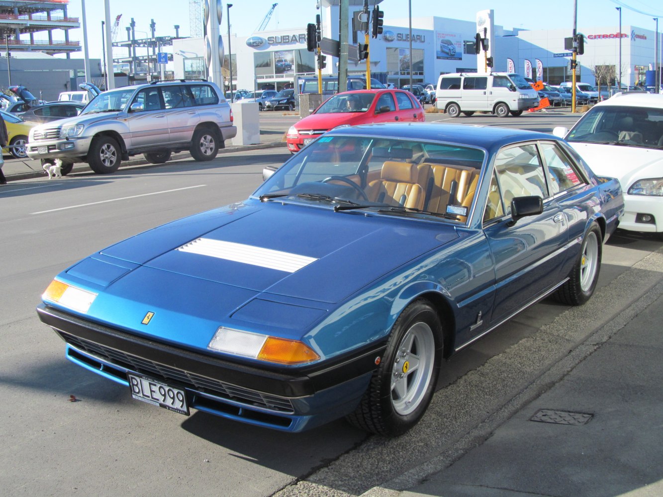 Vintage coupe with distinctive hood scoop and sporty alloy wheels