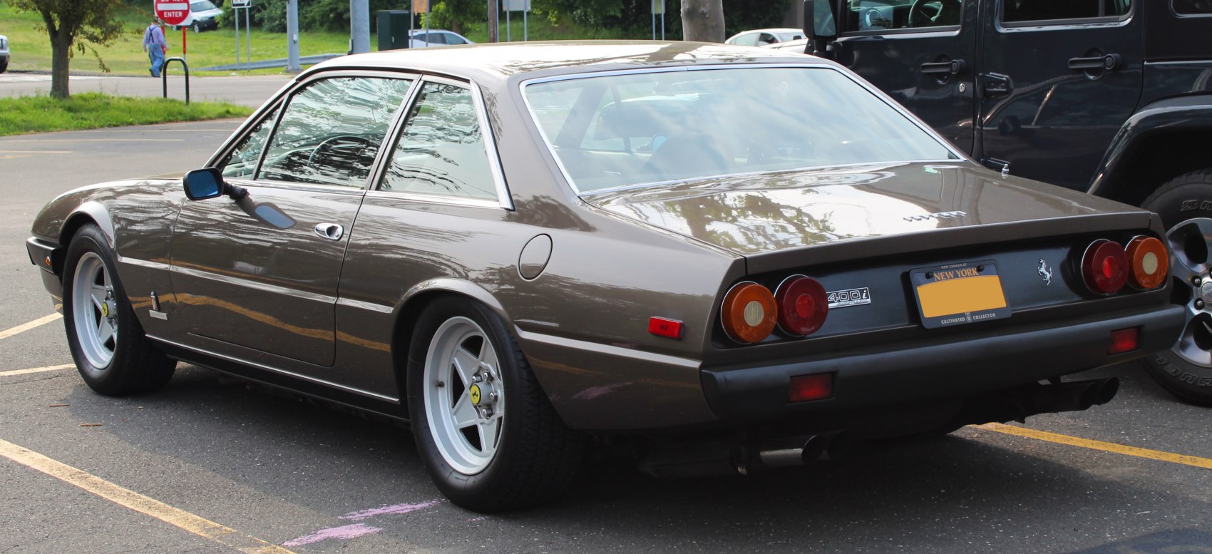 Rear view of vintage coupe with round tail lights and alloy wheels