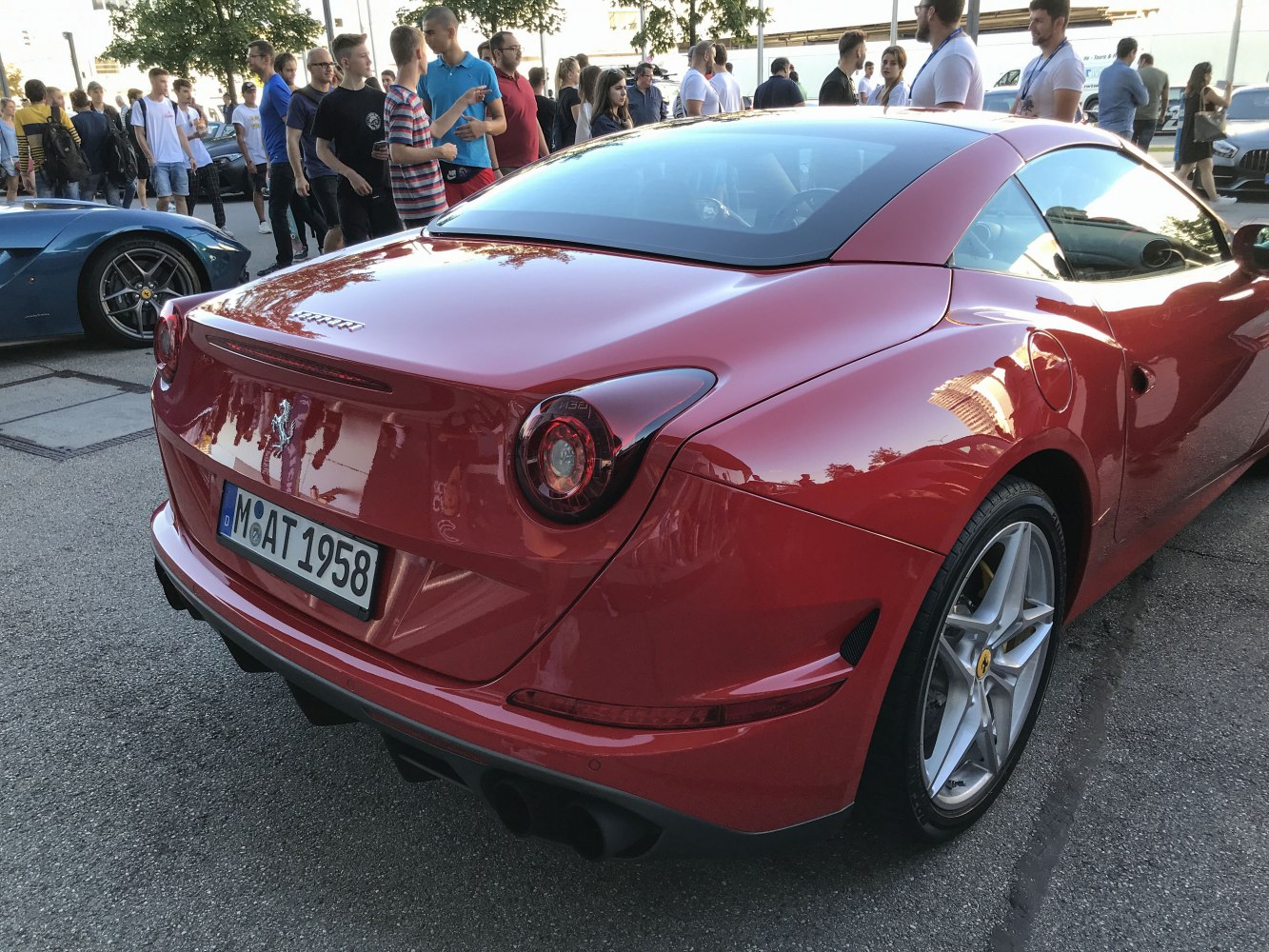 Rear view featuring tail lights, bumper, and alloy wheels of a sporty convertible.