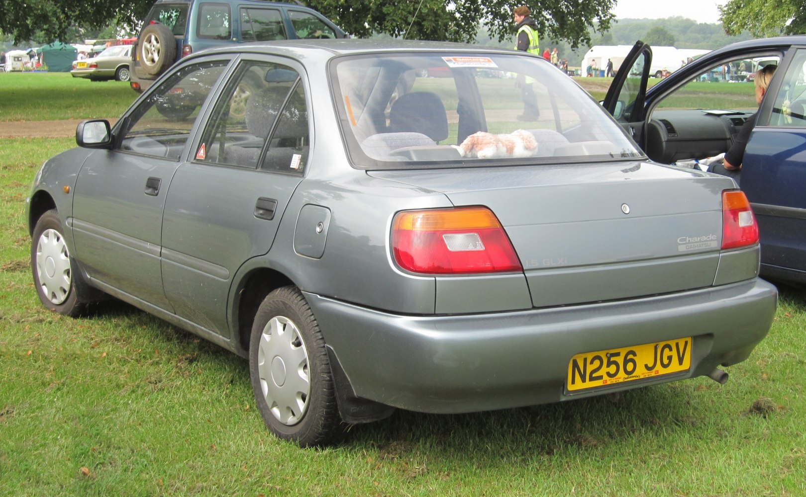 Rear and side view of a compact sedan with 1.5 GLXi badge and distinctive tail lights