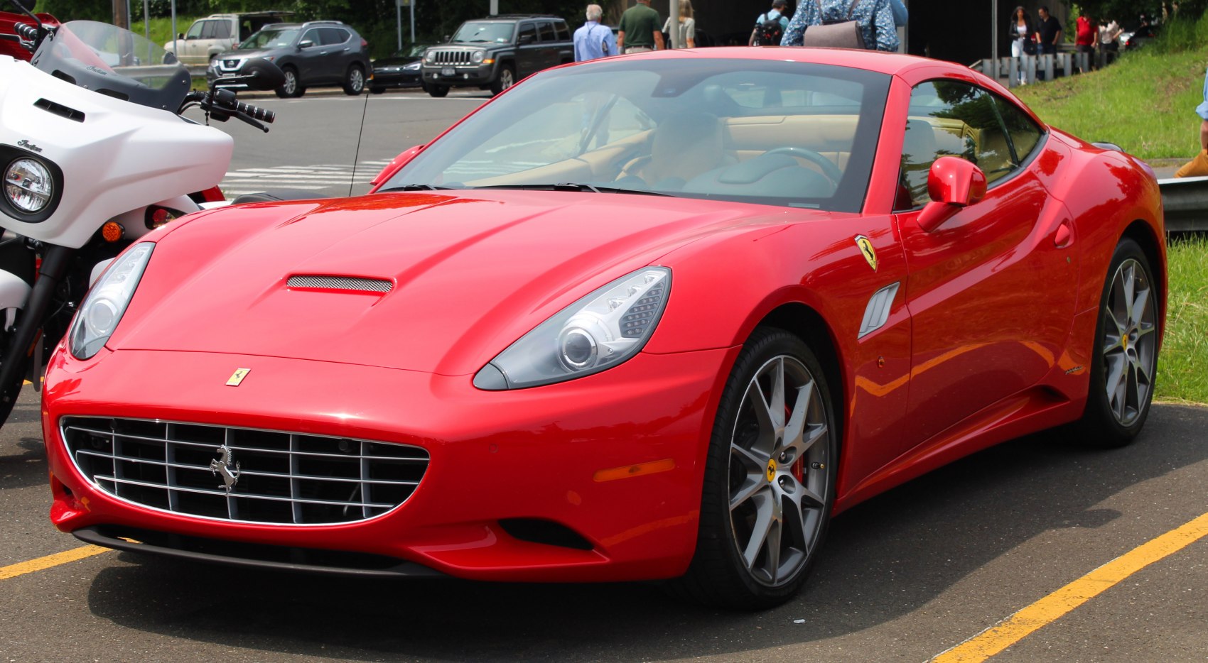 Front view of a red sports coupe with sleek design and distinct headlights