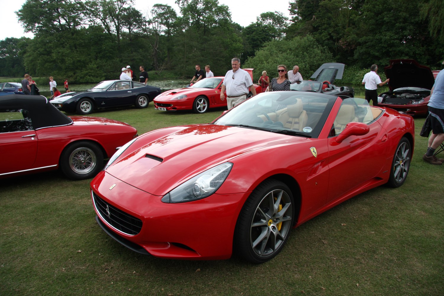 Red convertible with sporty design, alloy wheels, front view.