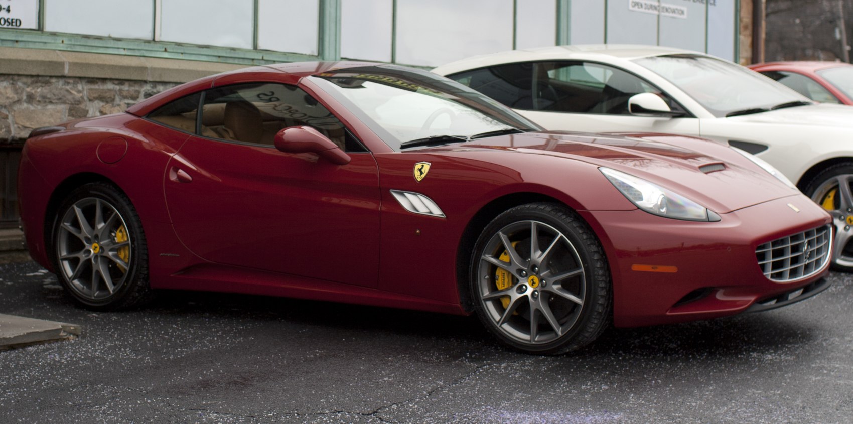 Red sports coupe with yellow brake calipers and alloy wheels