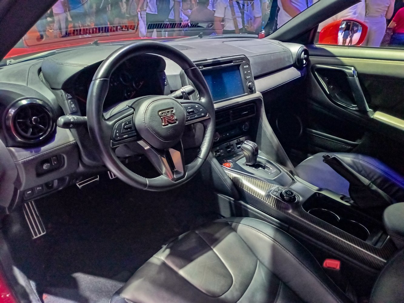 Luxury steering wheel and central console with leather seats and infotainment screen