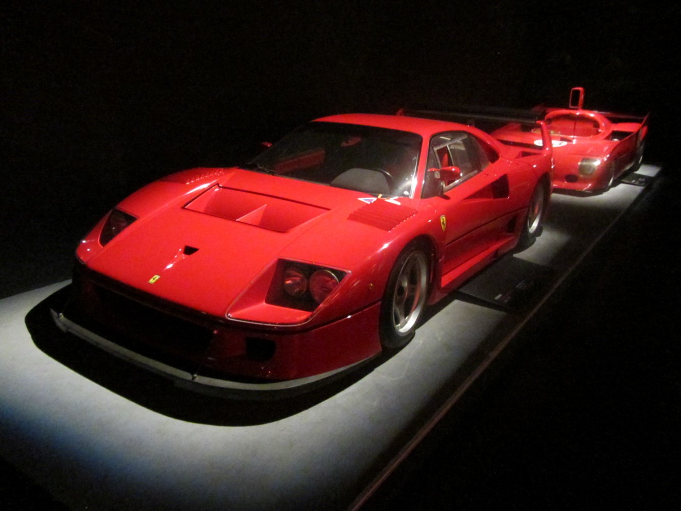 Racing sports coupe with aerodynamic vents, headlight pods, and sleek mirrors