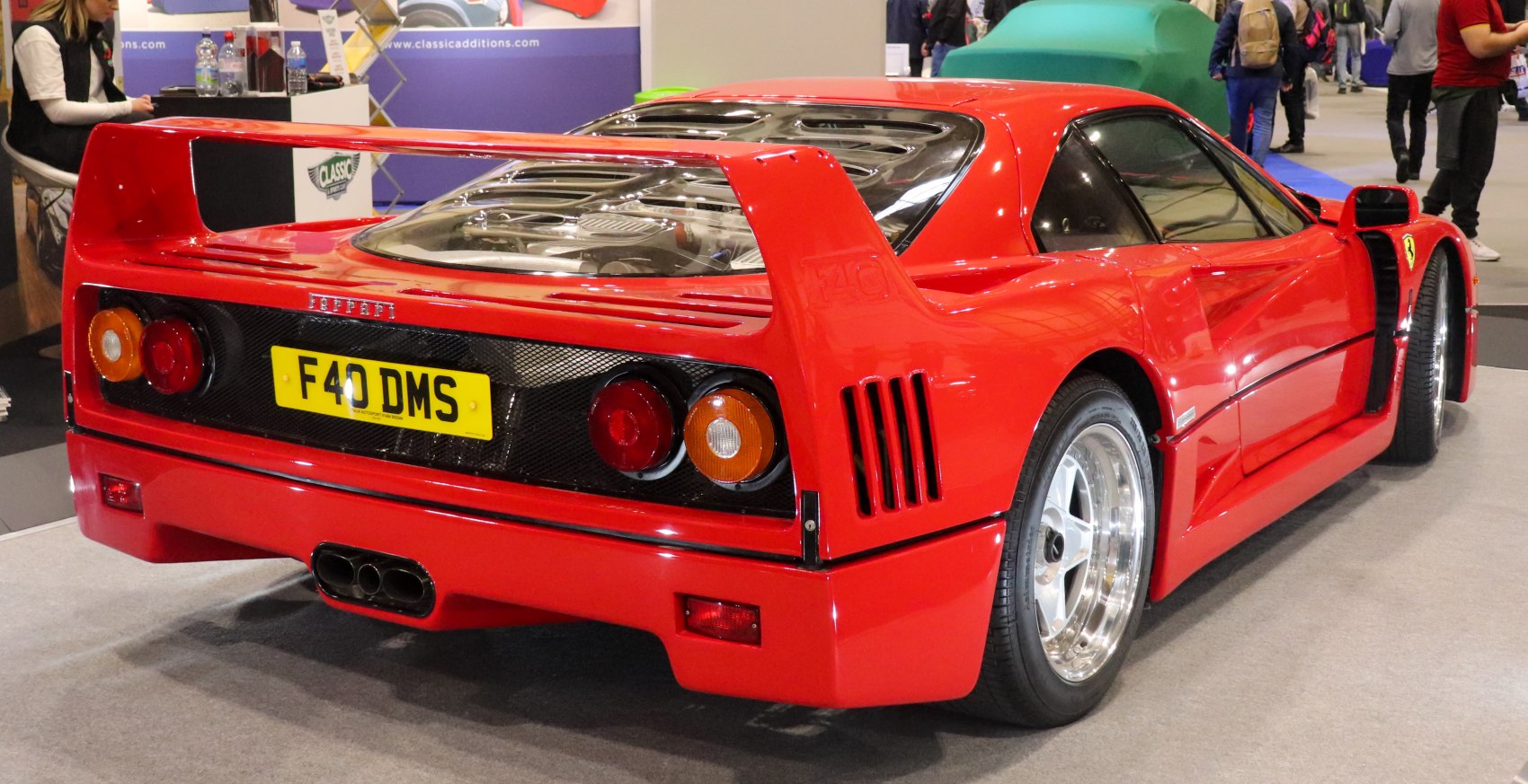 Rear spoiler, tail lights, and engine cover of a classic sports car