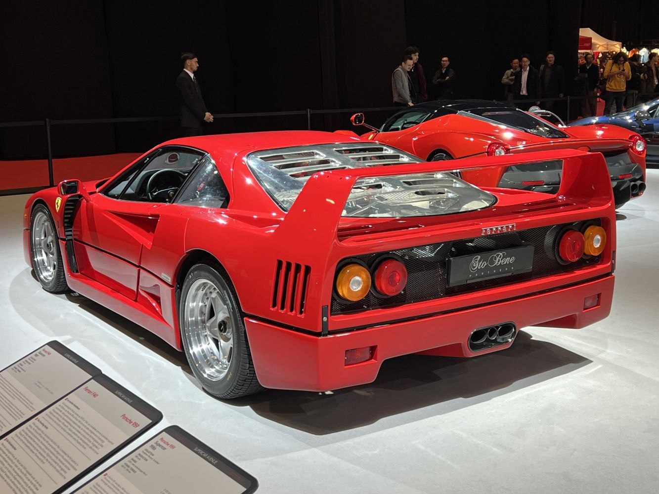 Rear view of a classic sports car with prominent rear wing and distinctive round taillights
