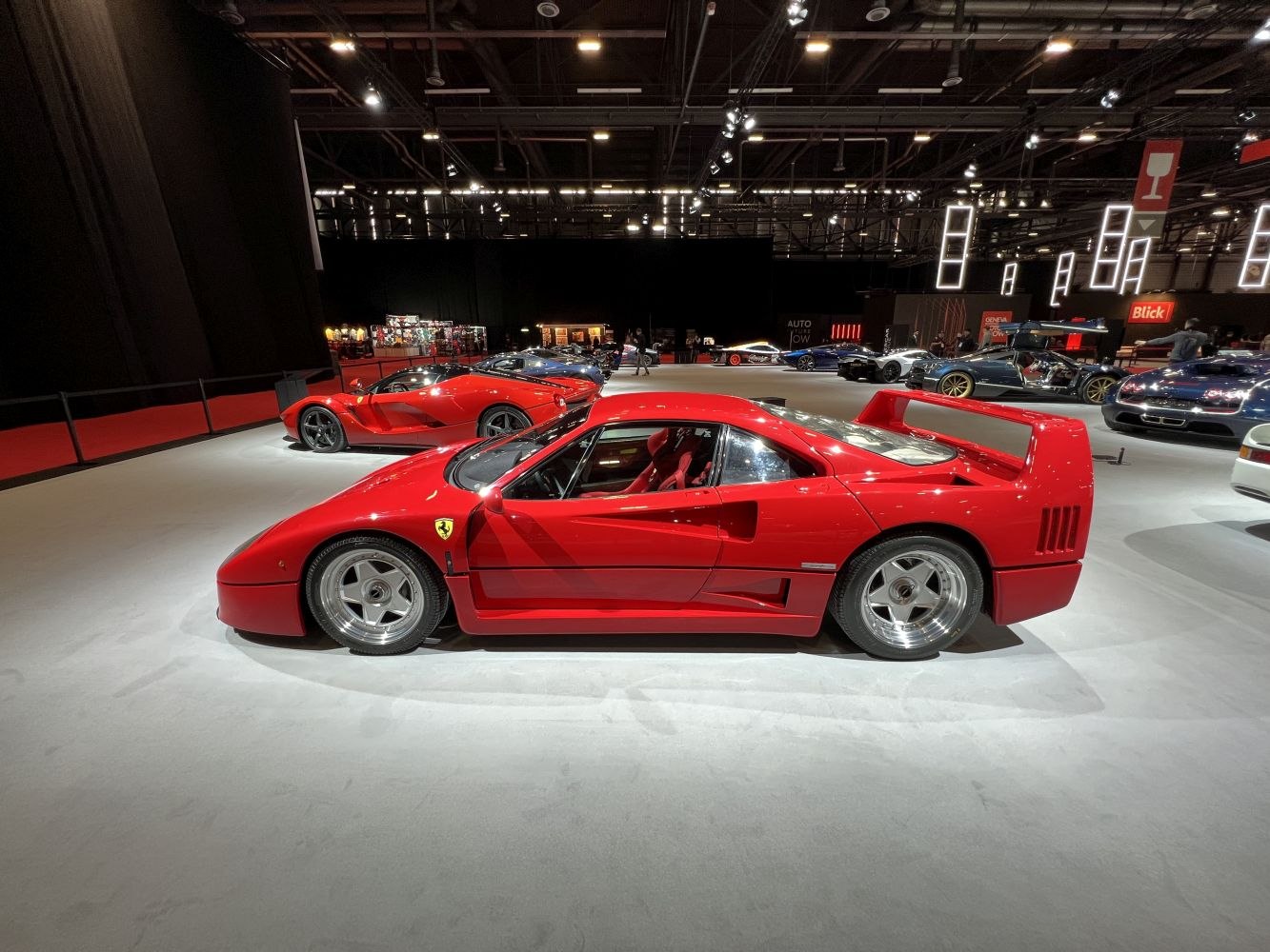 Side profile featuring large rear wing and 5-spoke alloy wheels