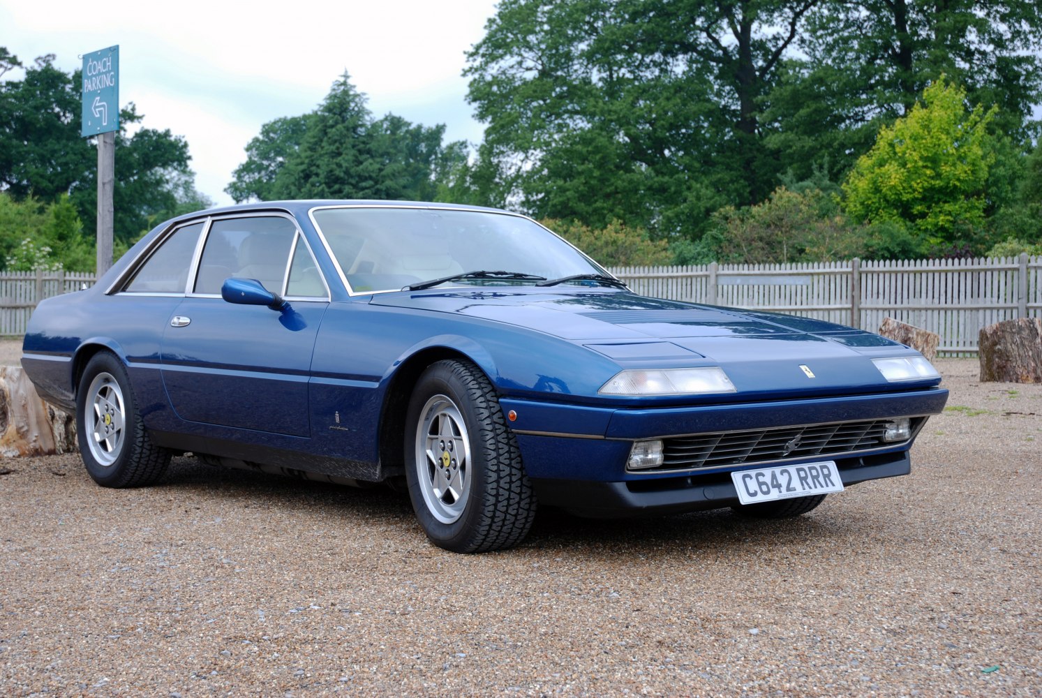 Blue sports coupe with pop-up headlights and alloy wheels