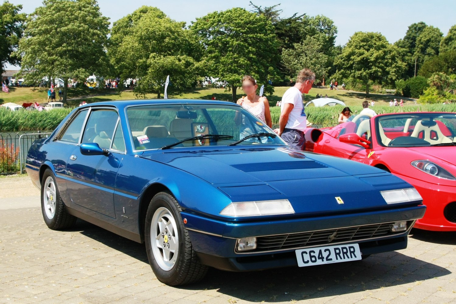 1980s coupe with vented hood, pop-up headlights, and prominent grille