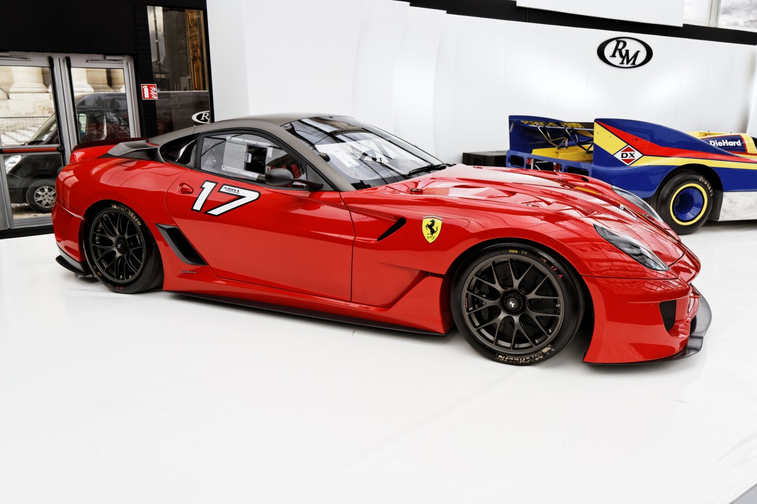 Red racing car with number 17 and black multi-spoke rims
