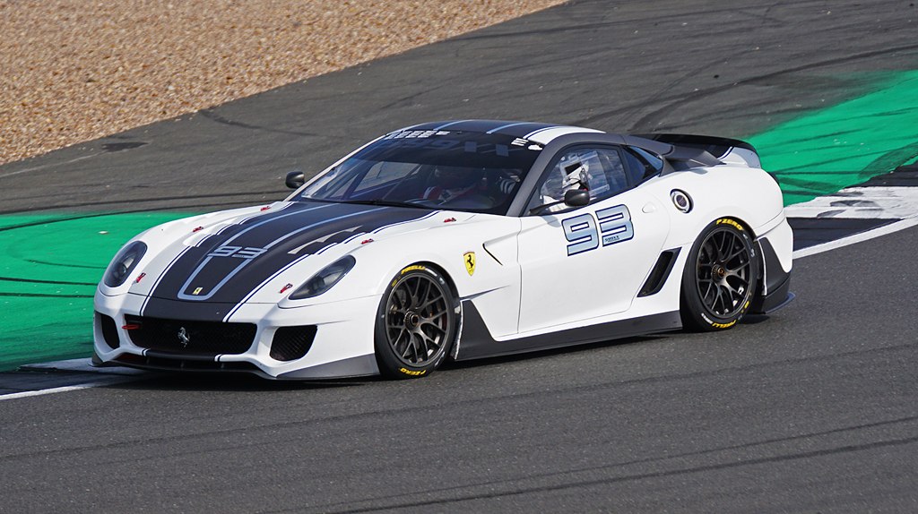 White high-performance race car with aerodynamic design on track