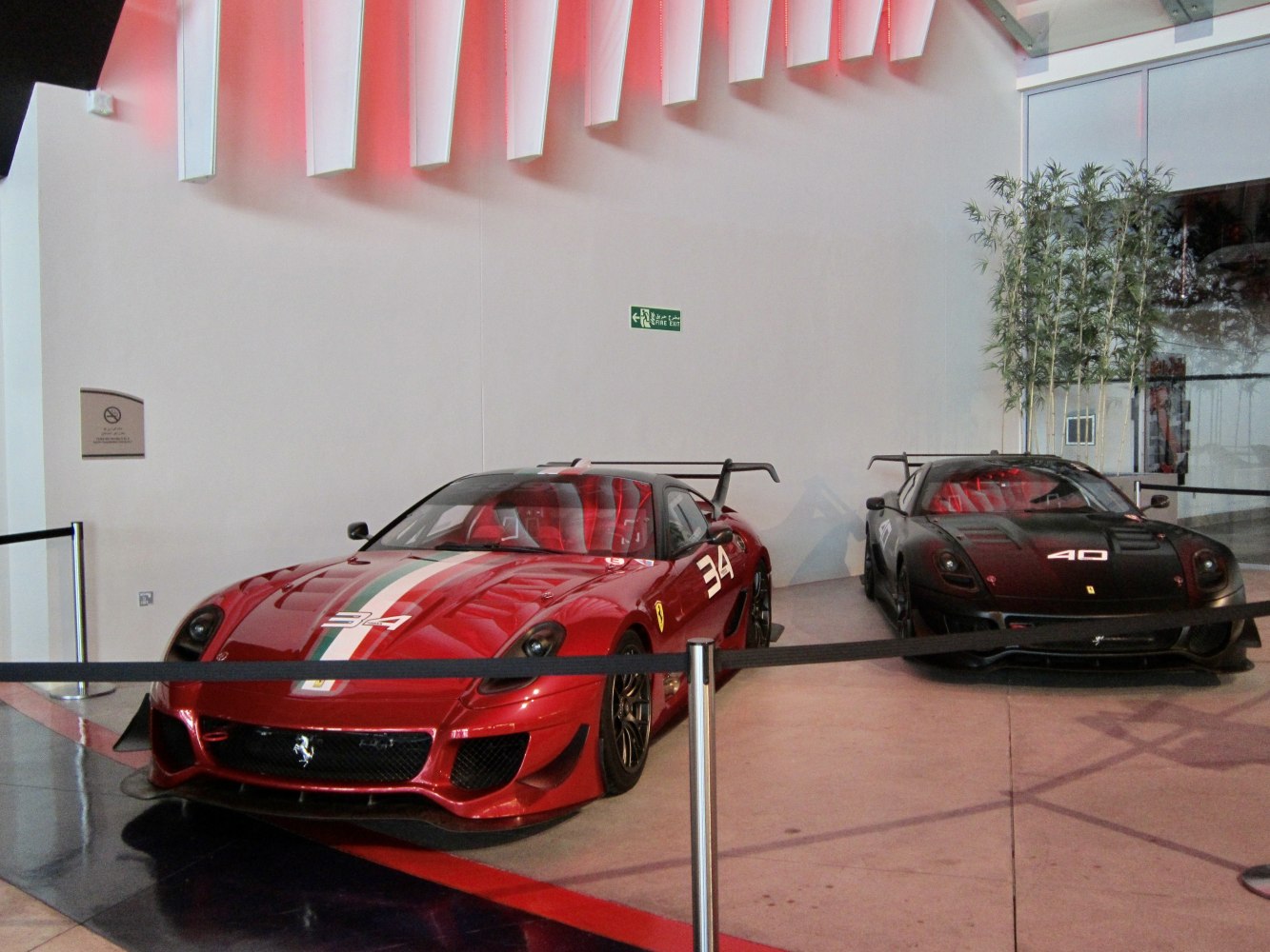 Two Ferrari 599XX race cars with prominent rear wings and racing liveries