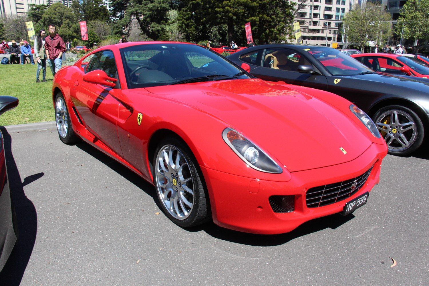 Red sports coupe with aerodynamic design and alloy wheels.