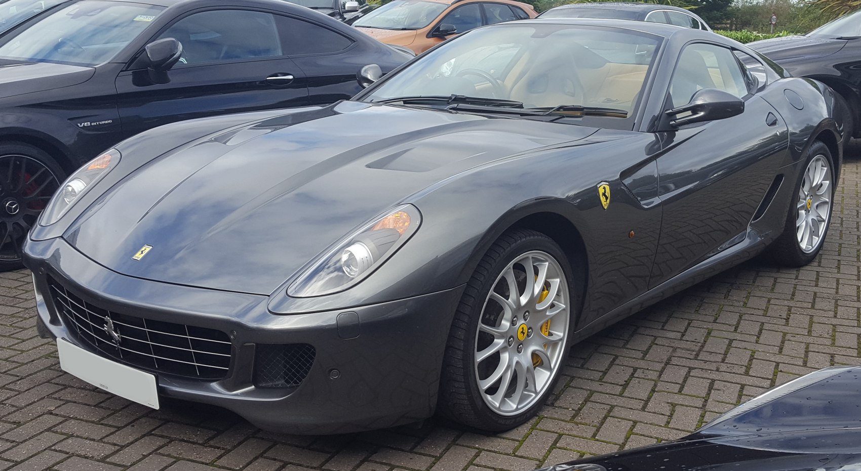 Front view of a sleek sports car with alloy wheels and side air vents