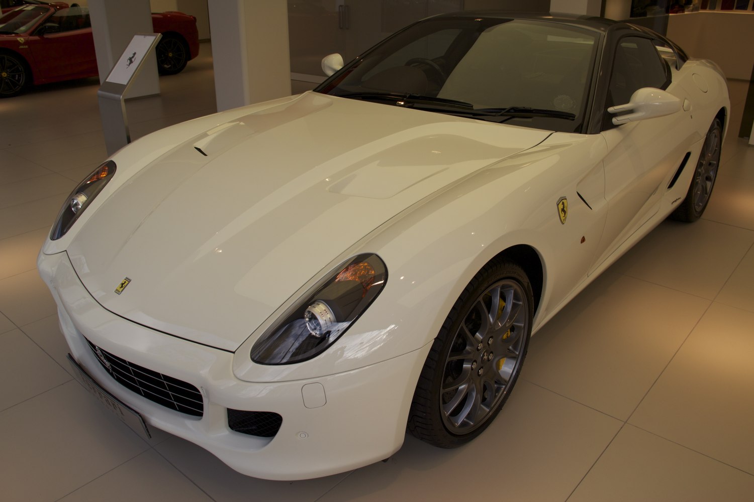 Sleek front side with aerodynamic hood and alloy wheels.