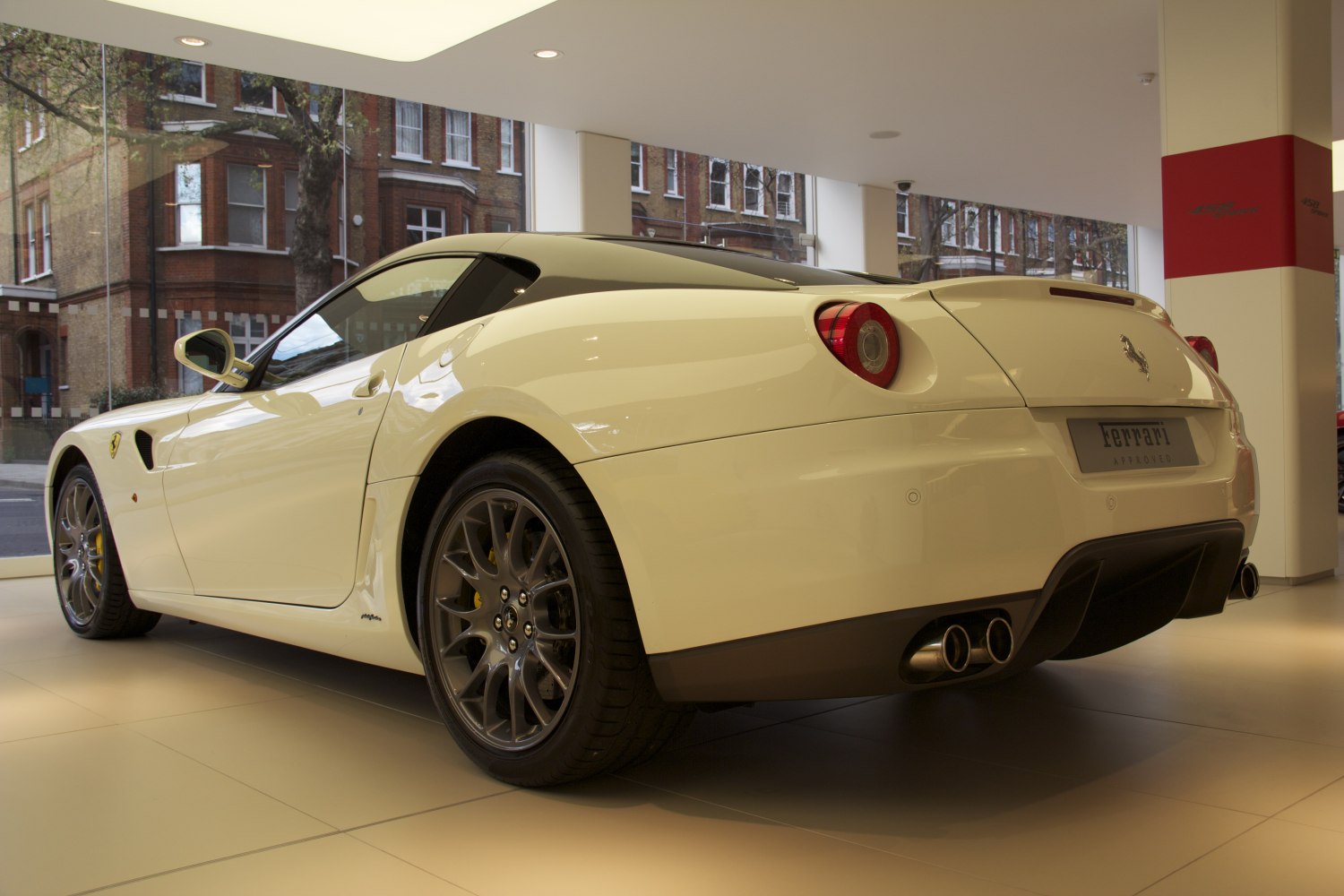 rear side view showing wheels and quad exhaust pipes
