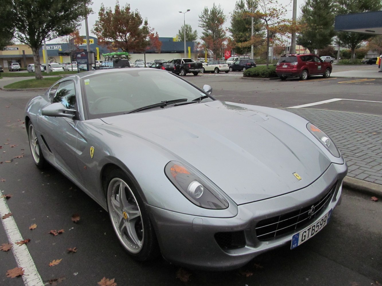 Silver sports coupe front view with prominent grille and headlights