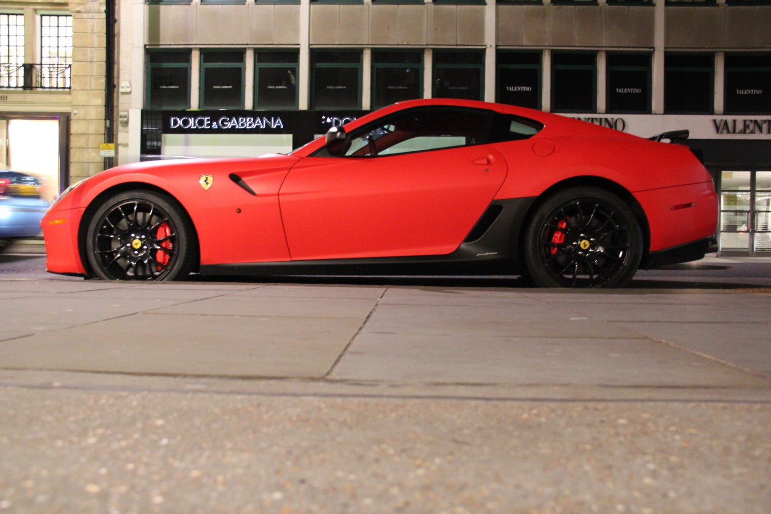 Matte red coupe with black rims and red calipers