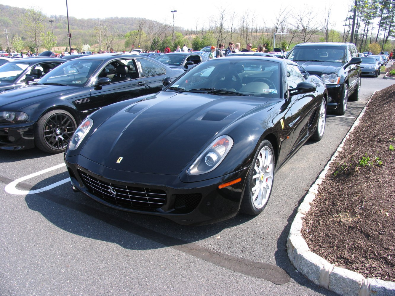Front view of a sleek car with distinctive headlights and sporty body design.