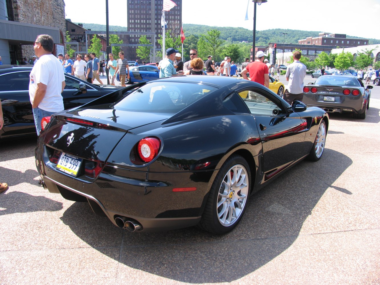 Rear view of a black sports coupe with dual exhaust and large alloy wheels