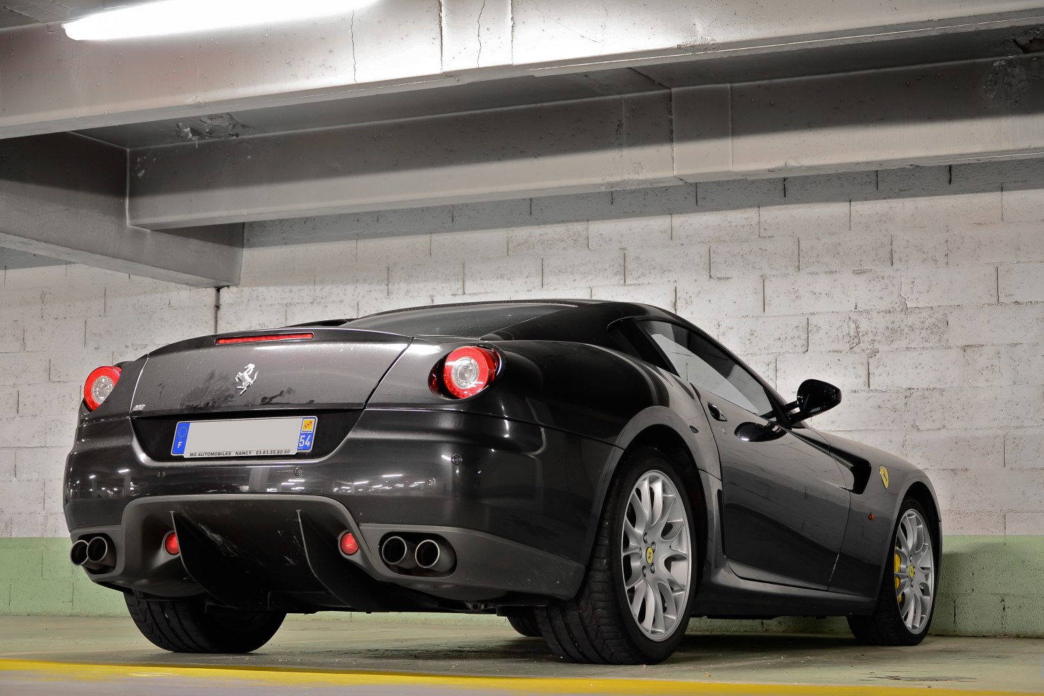 Sleek 2-door coupe with round taillights and quad exhaust pipes