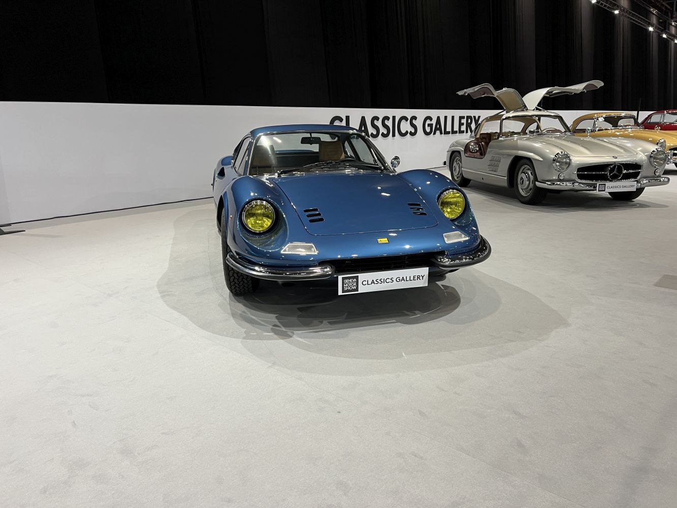Front view of classic Ferrari with yellow headlights and vintage sleek body
