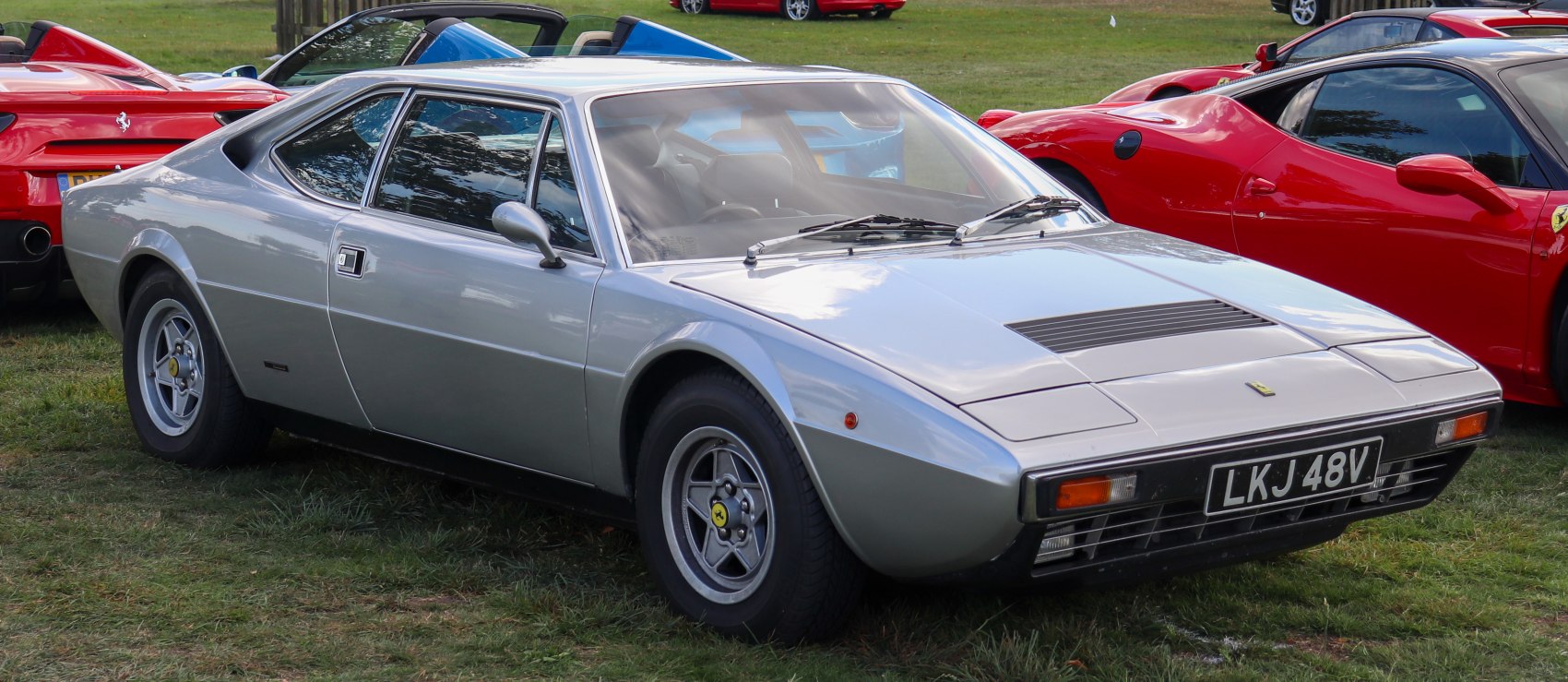 Vintage sports coupe with louvered hood and pop-up headlights
