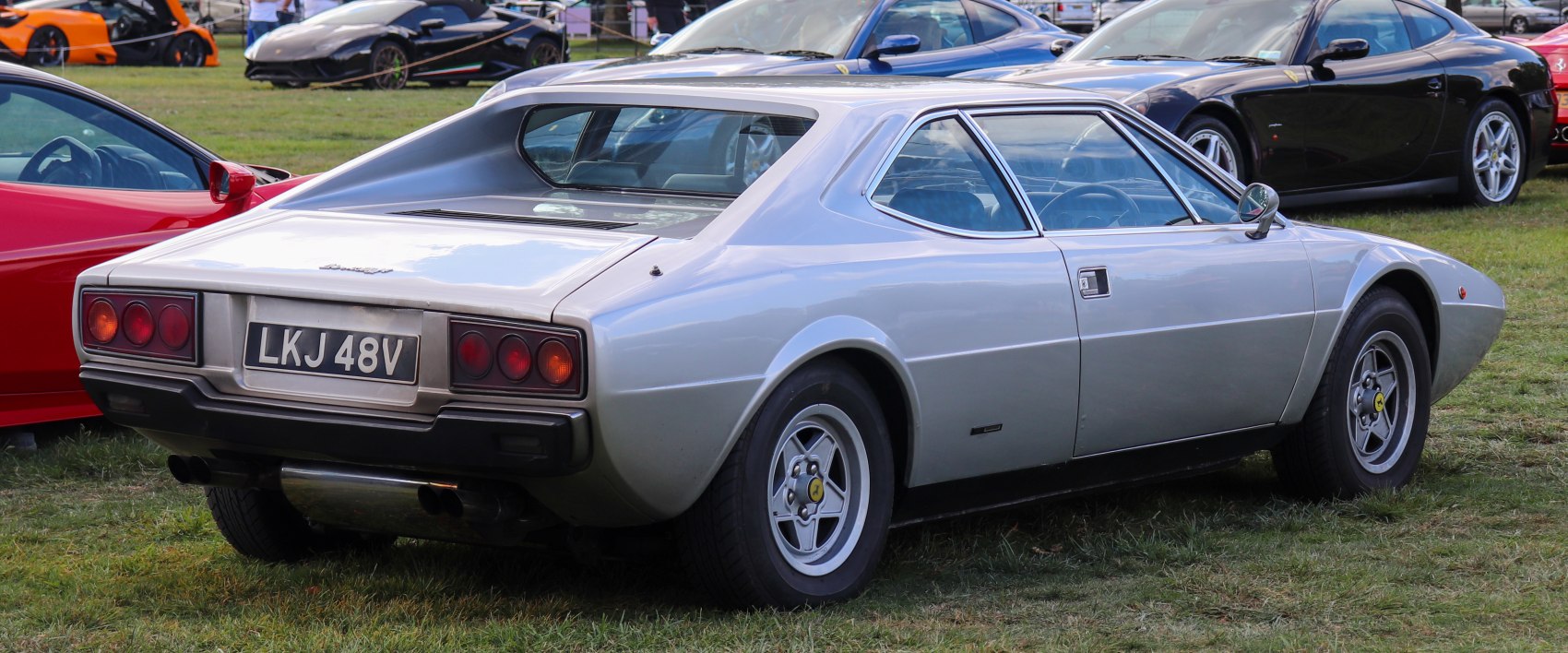 Rear view of a vintage sports coupe with quad taillights and rear spoiler