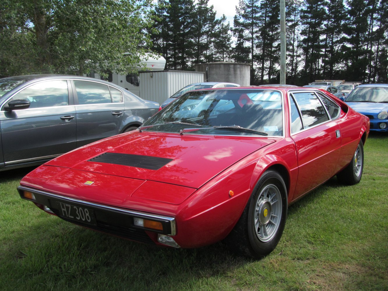 Red sports coupe with pop-up headlights and alloy wheels