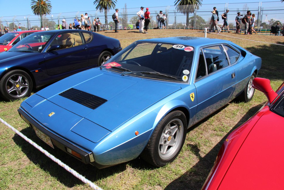 Blue vintage coupe with distinctive angular design and mid-engine layout